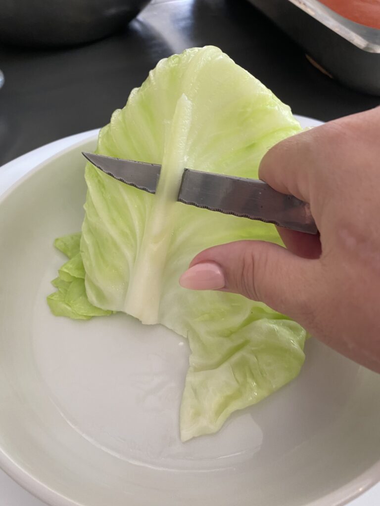 Trimming the rib on a cabbage leaf for cabbage rolls