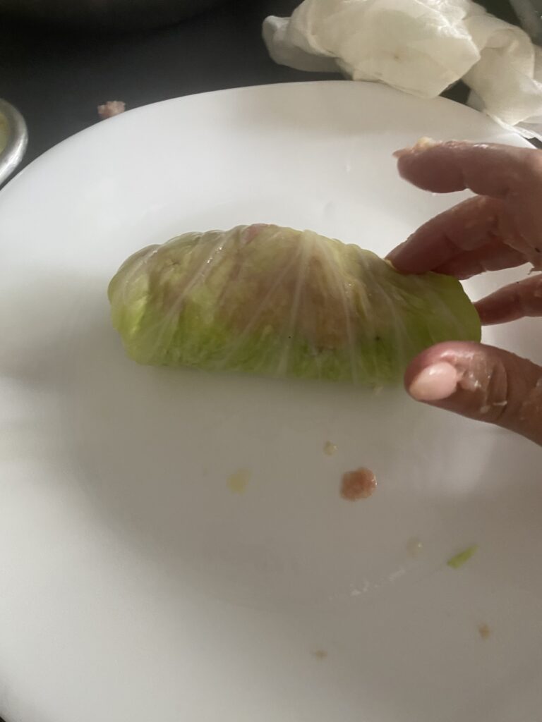 Finished homemade cabbage roll with pork and rice filling enclosed inside the cabbage leaf